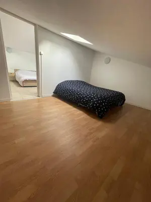 a bedroom with a bed in the corner of a room at Appartement en campagne avec jardin et piscine in Grans