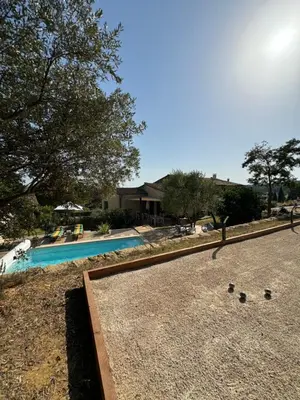 a swimming pool with some rocks on the ground at La Grange de Paulette in Bédoin