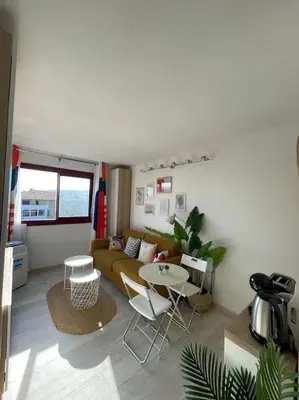 a living room with a couch and a table at Charmant Studio à 5 min d’Aix en Provence in Aix-en-Provence