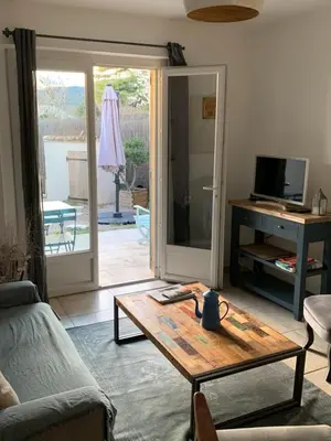 a living room with a coffee table and a sliding glass door at Maison de charme à Lourmarin in Lourmarin