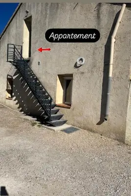 a sign on the side of a building with a staircase at Spacieux studio 2 à 3 personnes au pied du Ventoux km Zéro in Bédoin