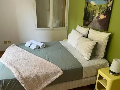 a bed with two rolled up towels on it at la grande villa in Aix-en-Provence
