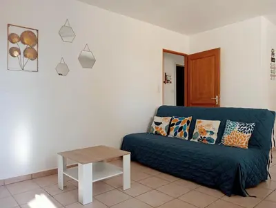 a living room with a couch and a table at Gîte PITCHOU au pied du VENTOUX in Flassan