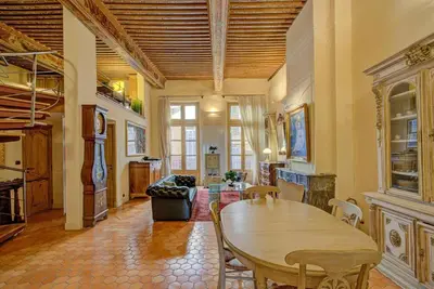 a living room with a wooden table and chairs at Maison des Arts Aix en Provence Apartment in Aix-en-Provence