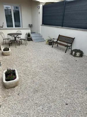 a patio with a bench and a table and chairs at Appartement cosy avec cour privée & terrasse Calme idéal couples familles in Cavaillon