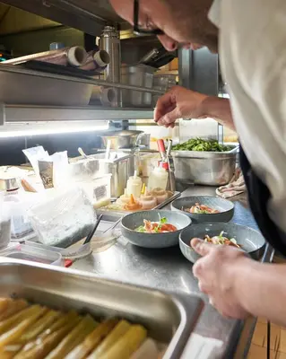 a chef preparing food in a restaurant kitchen at Domaine Gao in Aix-en-Provence