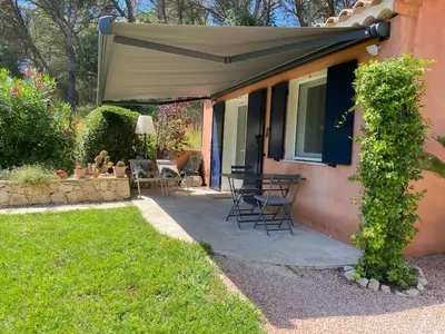 a patio with a table and chairs under an umbrella at la chamade grande chambre B&B indépendante in Ventabren