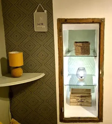 an open refrigerator with a clock on a shelf at Au Lys rose in LʼIsle-sur-la-Sorgue