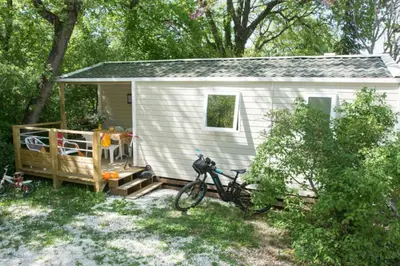a bicycle parked in front of a tiny house at Camping Le Luberon in Apt
