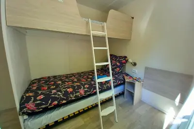 a bunk bed and a ladder in a room at Camping Le Luberon in Apt