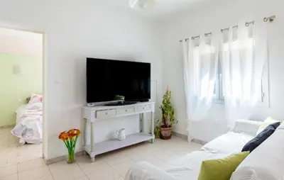 a living room with a flat screen tv on a white table at Gorgeous Home In Miramas in Miramas
