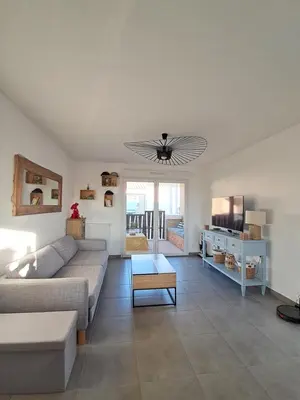 a living room with a couch and a table at Appartement cosy centre Robion in Robion en Luberon