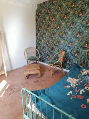 a bedroom with a bed and a chair and a wall at Bedoin Mas PASEVE in Bédoin