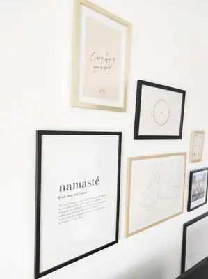 a gallery wall with framed diplomas and certificates at Le Cosy Valcros, design et confort in Aix-en-Provence
