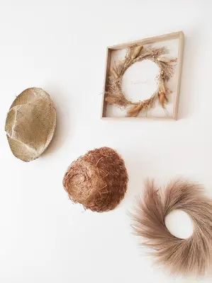 a wreath and a hat and a mirror with feathers at Le Cosy Valcros, design et confort in Aix-en-Provence