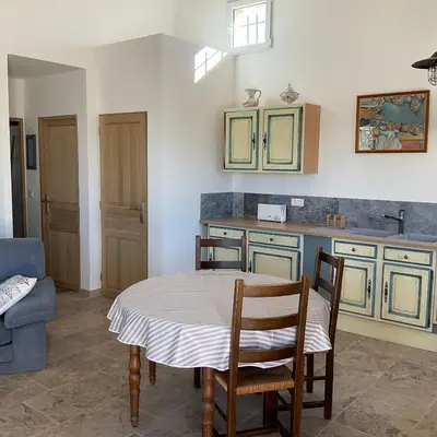 a kitchen with a table and chairs in a room at La jasse in Cabrières-dʼAigues