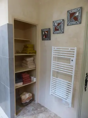 a wooden cabinet and a chair in a room at 2 chambres au calme Villa Chrisma Provence in Orgon