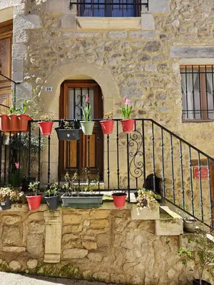a house with potted plants on a balcony at la petite maison in Céreste