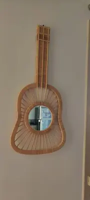 a mirror hanging on a wall with a guitar at maison_du_sud_13140 in Miramas