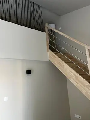 a staircase in a room with white walls at Le capèu in Mollégès
