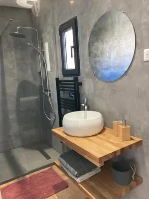 a bathroom with a sink and a mirror and a shower at Gîte Thaliana in Saumane-de-Vaucluse