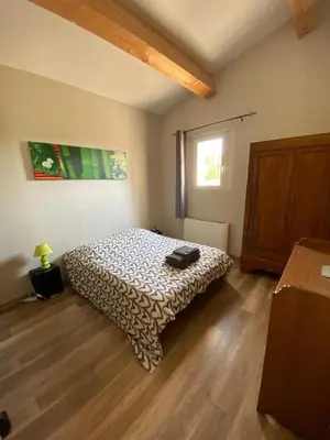 a bedroom with a bed and a wooden floor at Le bon Vivre in Aix-en-Provence