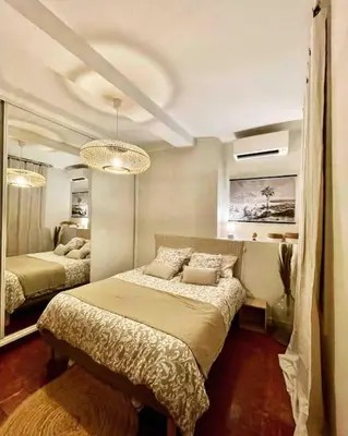 a bedroom with two beds and a large mirror at Charmant T2bis coeur historique, Clim, possibilité garage in Aix-en-Provence
