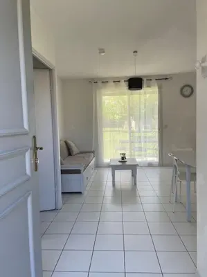 a living room with a couch and a table at Villa Tia - Appartement 2 chambres - piscine - bord de lac in Saint-Saturnin-lès-Avignon