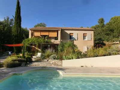 a house with a swimming pool in front of it at Les Lavandes in Saignon