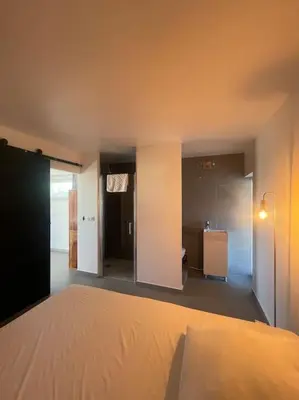 a bedroom with a bed and a room with a bathroom at Dépendance au sein d’une villa avec piscine in Aix-en-Provence