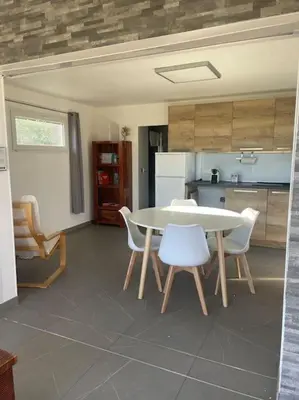 a kitchen with a table and chairs in a room at Dépendance au sein d’une villa avec piscine in Aix-en-Provence