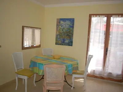 a dining room with a table and chairs and a window at Camargue Modern retreat in Cavaillon