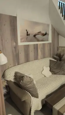 a bed in a room with two people on the beach at Gite au nid d'Ange in Lincel