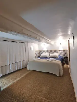 a bedroom with a large bed and a window at Appartement centre historique Aix en Provence, Place RAMUS in Aix-en-Provence