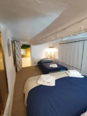 two beds in a room with blue sheets at Appartement centre historique Aix en Provence, Place RAMUS in Aix-en-Provence