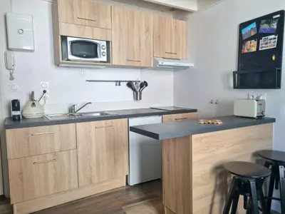 a kitchen with a sink and a microwave at Joli studio en plein centre historique in Aix-en-Provence