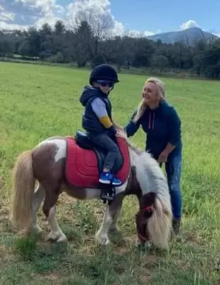 a woman and a child riding on a horse at Séjour à la ferme in Jouques