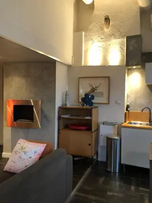a living room with a couch and a kitchen at AIX Centre LOFT Duplex Terrasse climatisation wifi in Aix-en-Provence