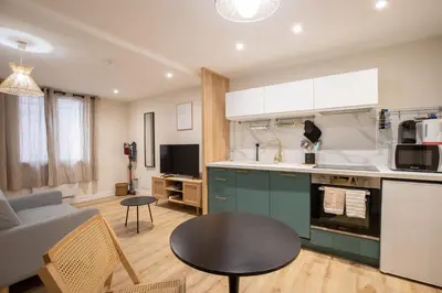 a kitchen and living room with a couch and a table at Le Triplex - 8 pers - Hypercentre - Wifi in LʼIsle-sur-la-Sorgue