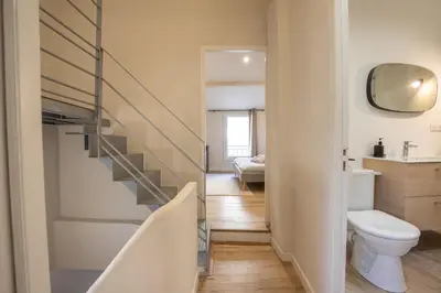 a bathroom with a staircase and a toilet in it at Le Triplex - 8 pers - Hypercentre - Wifi in LʼIsle-sur-la-Sorgue