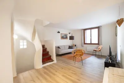 a living room with a couch and a table at Le Triplex - 8 pers - Hypercentre - Wifi in LʼIsle-sur-la-Sorgue
