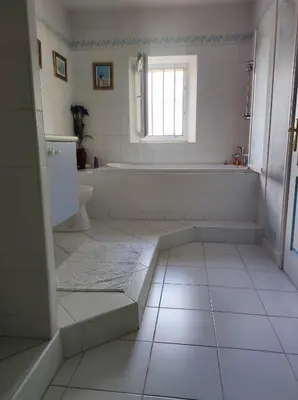 a white bathroom with a tub and a sink at Chambre 3 personnes avec salle de bain dans mas du Lubéron in Robion en Luberon