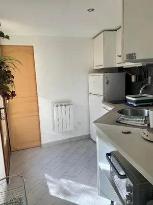 a kitchen with white cabinets and a counter top at A 20 minutes de Aix en Provence in Pertuis