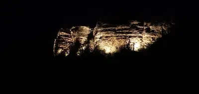 a rock formation with lights on it at night at CHRIS LE VERGER in Saignon