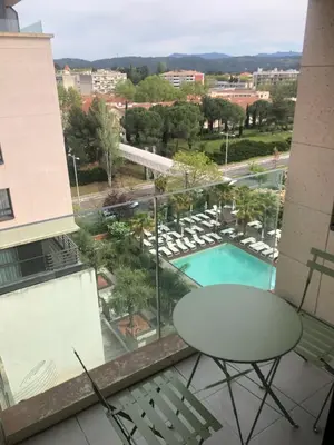 a balcony with a table and chairs and a pool at ITER House \uc774\ud130 \ud558\uc6b0\uc2a4 in Aix-en-Provence