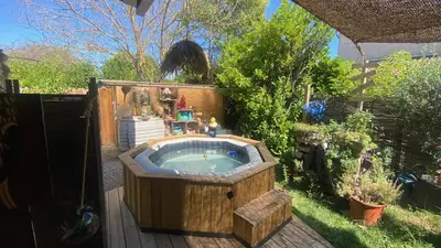 a jacuzzi tub in a garden in a yard at Nouveau ENVOUTEMENT près de GORDES Provence Maison entière neuve archi luxe écolo 4 pers parking privé in Robion en Luberon