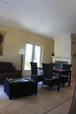 a living room with a couch and a table at Les Pres de Gordes in Gordes