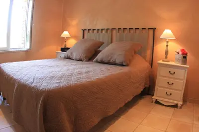 a bedroom with a bed with two pillows on it at Les Pres de Gordes in Gordes