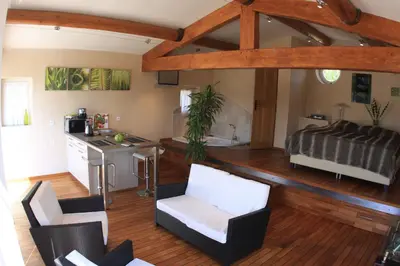a room with a kitchen and a living room at Les Pres de Gordes in Gordes