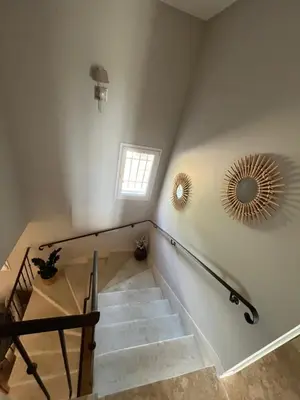 a staircase with a mirror on the wall and a mirror at Mas Provençale entre Avignon et St Remy de Provence in Noves